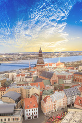 Fototapeta na wymiar Beautiful view of the old town and the steeple of the Dome Cathedral near the Daugava River in Riga, Latvia