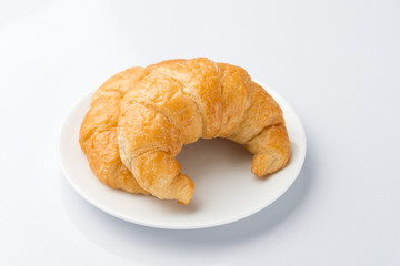 2 Delicious croissants on a white plate on a white background.