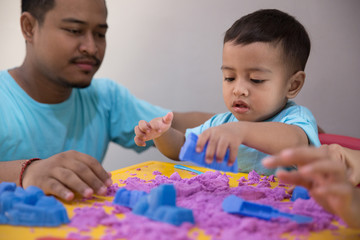 asian kid play sand indoor