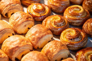 Croissants in a bakery shop. freshly baked croissants on texture background.