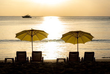 Luxury yellow beach umbrella and beach chair setup on Kamala beach, phuket, thailand