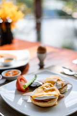 Egg benedict for breakfast on the table in hotel restaurant