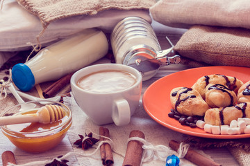 Breakfast of coffee, croissants, milk, honey, sugar, cinnamon, anise