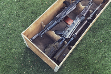 army box ammunition with AK47 rifle and ammunition. An automatic weapon with a sniper scope in wood...