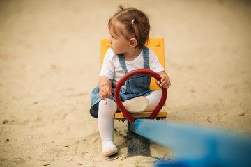 Happy child walks in the park and playing in playground