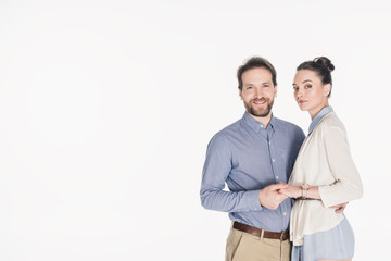 portrait of smiling married couple holding hands together isolated on white