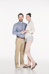 married couple holding hands together and looking at camera isolated on white