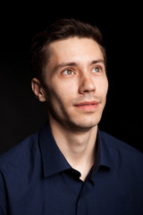 Obraz premium Fashion portrat of young man on black background in studio photo