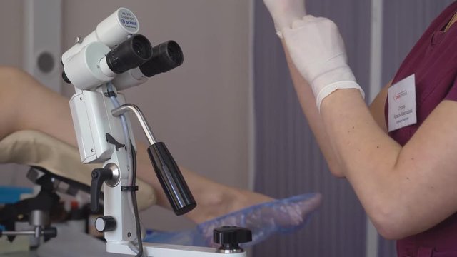 attractive female gynecologist examining patient in armchair HD