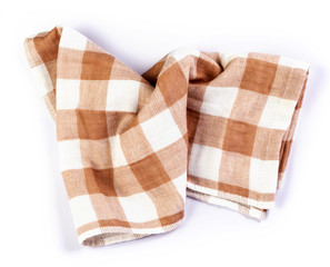 a crumpled orange brown checkered napkin table clothes  on white background.