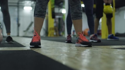 Strong muscular athletes working out training with kettlebells.