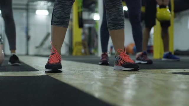 Strong muscular athletes working out training with kettlebells.