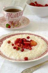 A useful breakfast of rice porridge with strawberry sauce served with tea.