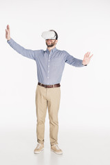 bearded man in virtual reality headset with outstretched arms isolated on white