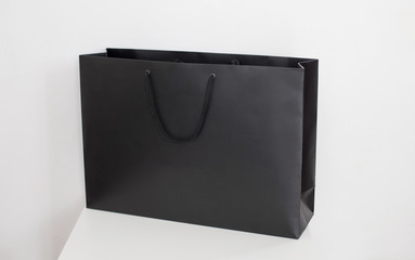 Package for purchases the black isolated on a white background. Paper bag black template mock up. Shopping concept