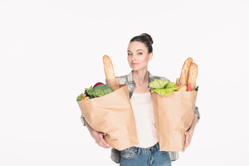 portrait of attractive woman holding paper packages with food isolated on white