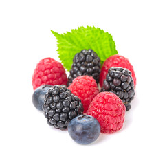 Healthy food berries group. Macro shot of fresh raspberries, blueberries and blackberries with leaves isolated on white background.