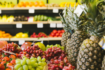 Shelves with fruits and vegetables in a supermarket or a store. Seasonal products.