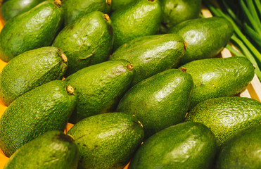 Beautiful and fresh avocado on a shelf in a supermarket. Seasonal and exotic vegetables and fruits