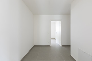 Detail of open doors in all-white apartment