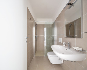 Fototapeta na wymiar Modern bathroom with large tiles in newly built apartment