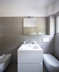 Modern bathroom with large tiles in newly built apartment
