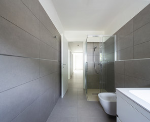 Modern bathroom with large tiles in newly built apartment