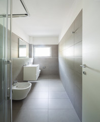 Modern bathroom with large tiles in newly built apartment
