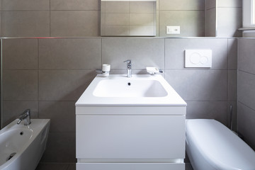 Modern bathroom with large tiles in newly built apartment