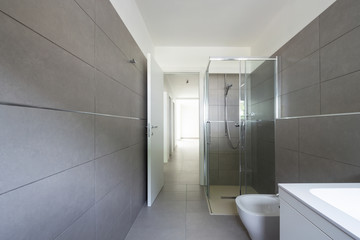 Modern bathroom with large tiles in newly built apartment