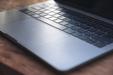 Closeup image of computer laptop on wooden table in cafe