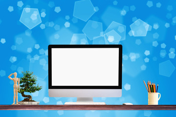 Mock up : Workspace with blank white desktop computer, pencils and stationery items. Blank screen for graphics display montage.