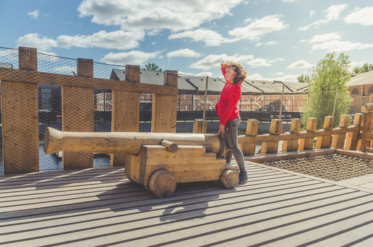 girl on a wooden Playground in the form of a pirate ship