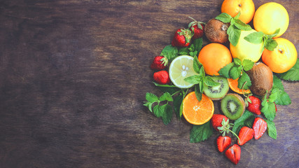 citrus fruits  and strawberries on a wooden background