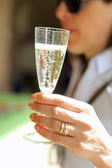 newly married wife with the engagement ring that lifts the glass