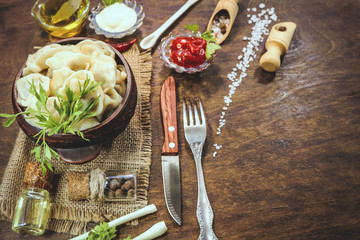 dumplings in earthenware. food ingredients. wooden background.