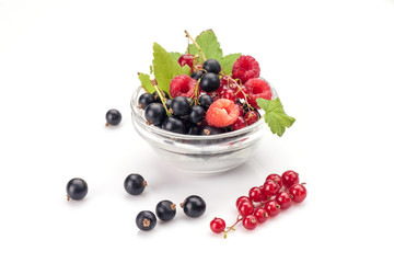 Mixed berries in glass bowl isolated on white background