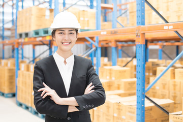 Female architect standing smiling at warehouse. People working concept.