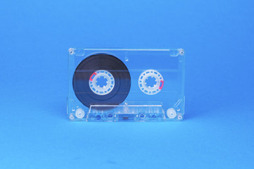 transparent audio cassette on blue background
