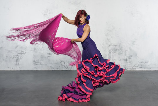 Flamenco dancer in action with the typical Spanish dance costume.