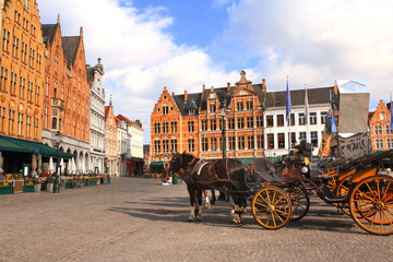 Old houses and horse carriages on Grote Markt square, Brugge, Belgium
