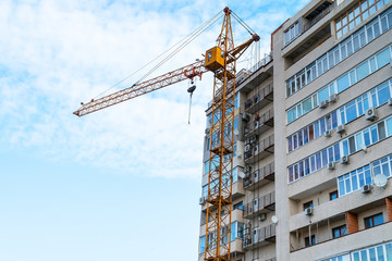 Fototapeta na wymiar Construction crane against the building