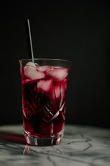 low key red cocktail with black straw