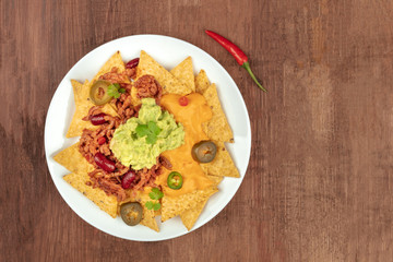 Nachos with cheese and chilli, traditional Mexican dish, with copyspace