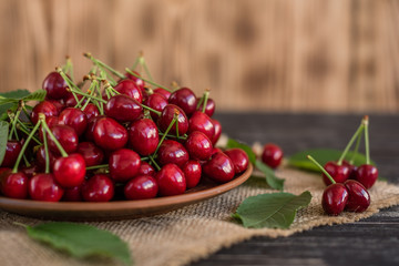 Tasty juicy sweet cherry on a wooden background. It can be used as a background