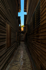 Narrow path down the alley is the pathway to Jesus between the old wooden houses in the countryside