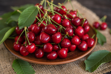 Tasty juicy sweet cherry on a wooden background. It can be used as a background