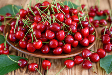 Tasty juicy sweet cherry on a wooden background. It can be used as a background
