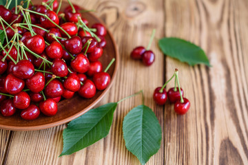 Tasty juicy sweet cherry on a wooden background. It can be used as a background