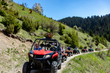 A tour group travels on ATVs and UTVs on the mountains © FS-Stock